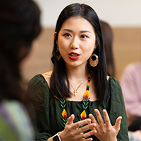 Staff member talking to a student.