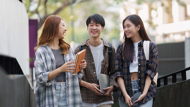 Three students walking together.