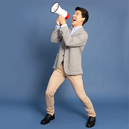 Main speaking confidently with a megaphone.