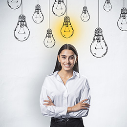 Woman with a set of light bulbs above her head, one is lit up, representing an idea generated.