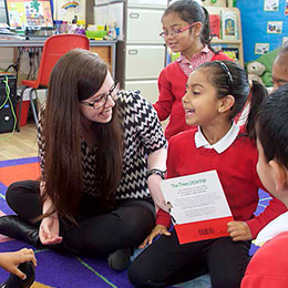 Woman in a school, working with students.